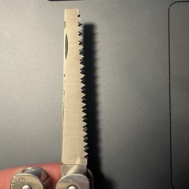 a small multitool saw cutting through thin wood board. it has an intresting rythym