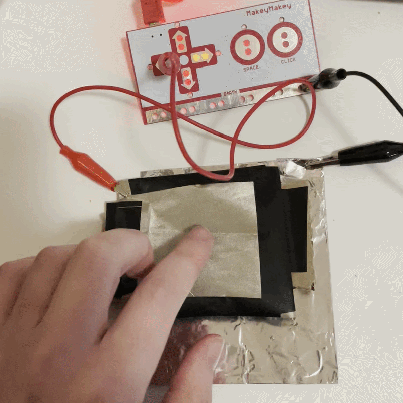 a number of my ideas from formstorming 1 involved fully body interaction or stepping on a touchpad to trigger an interaction. This is my first attempt at making a larger button that doesnt stay pushed down. Ideally a proper full size button would use springs and be more secured. However, due to my lack of materials, I made do with some peices of cardboard and conductive fabric pulled tight.
