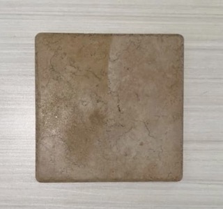 This is a stoneware floor tile. The material has been refined as its been taken from the earth, ground up, processed, reconstructed, and fired all before it has reached this point. It is incredibly rigid with no give before it just breaks. This material is used for floor tiling, ceramic art, mug making, and other ceramic uses.