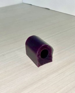 This is a ring starter made of jewlers wax. I think this is a chunk of raw jewlers wax that has been cut to shape. The material is very rigid with significant harness. This is necessary for it's purpose which is to help jewlers mold metal into the right shape which often requires a significant amount of force being put on it.